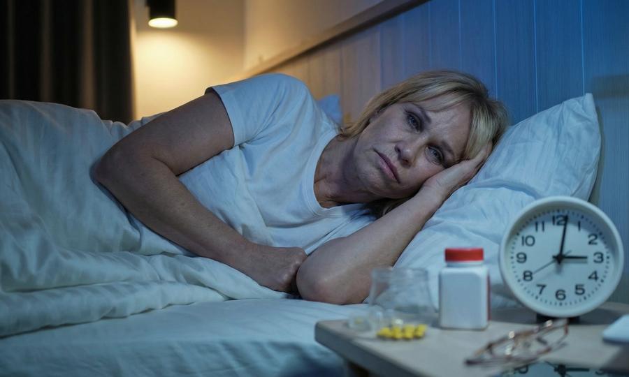 Adult lying awake in bed in the middle of the night