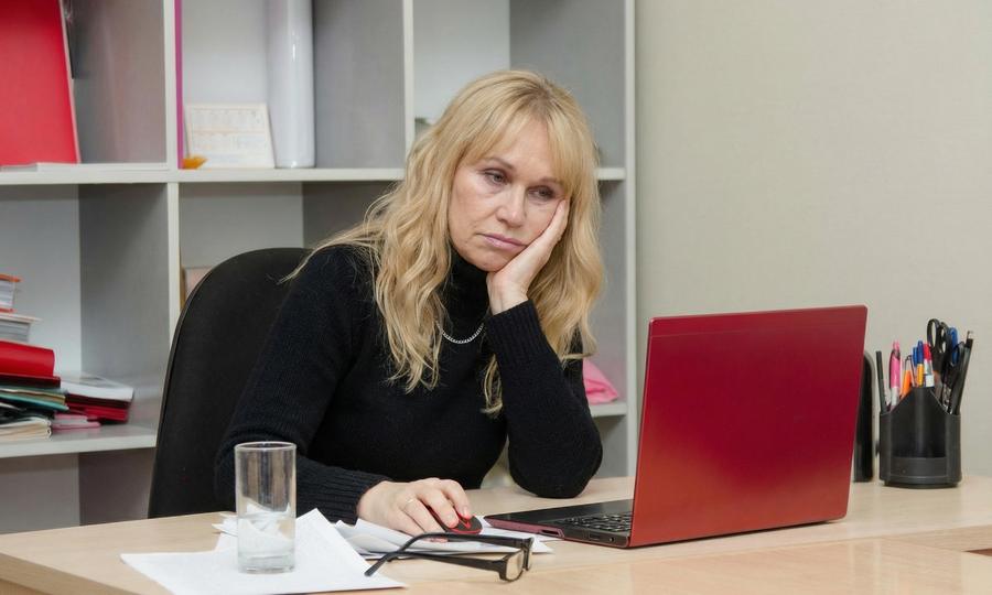 Exhausted person at desk in the morning